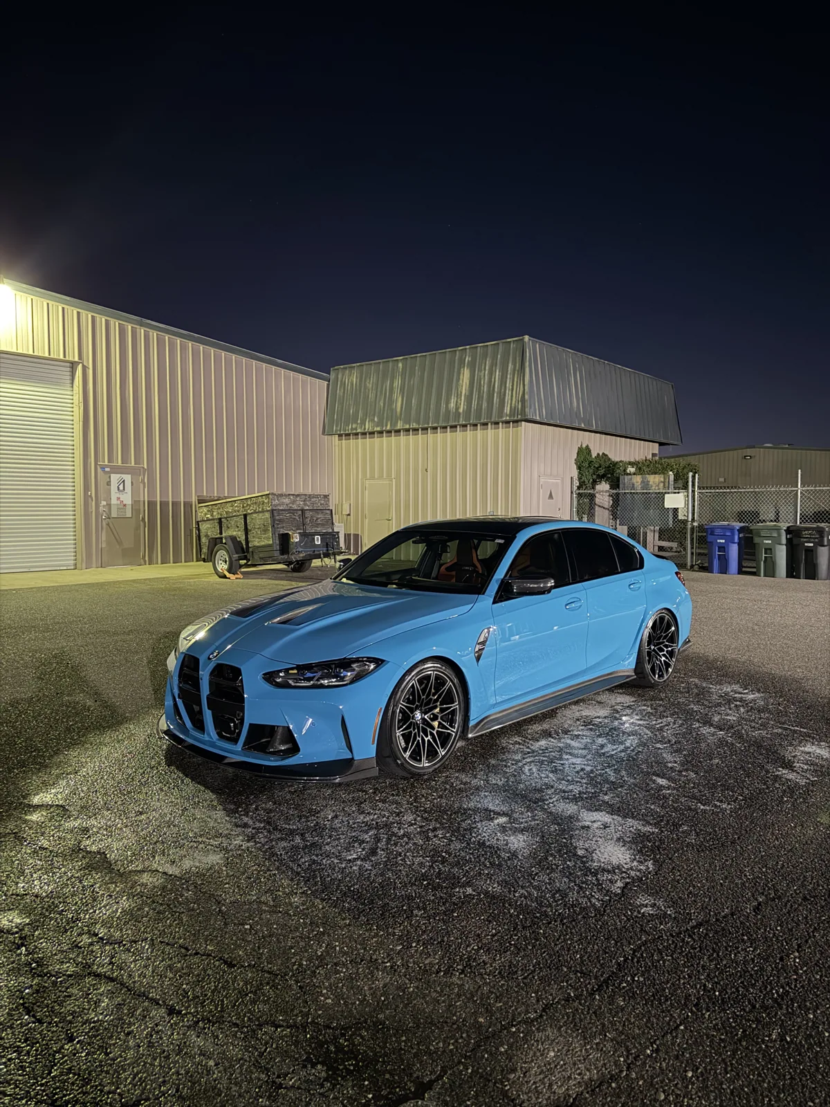 Blue BMW outside at night